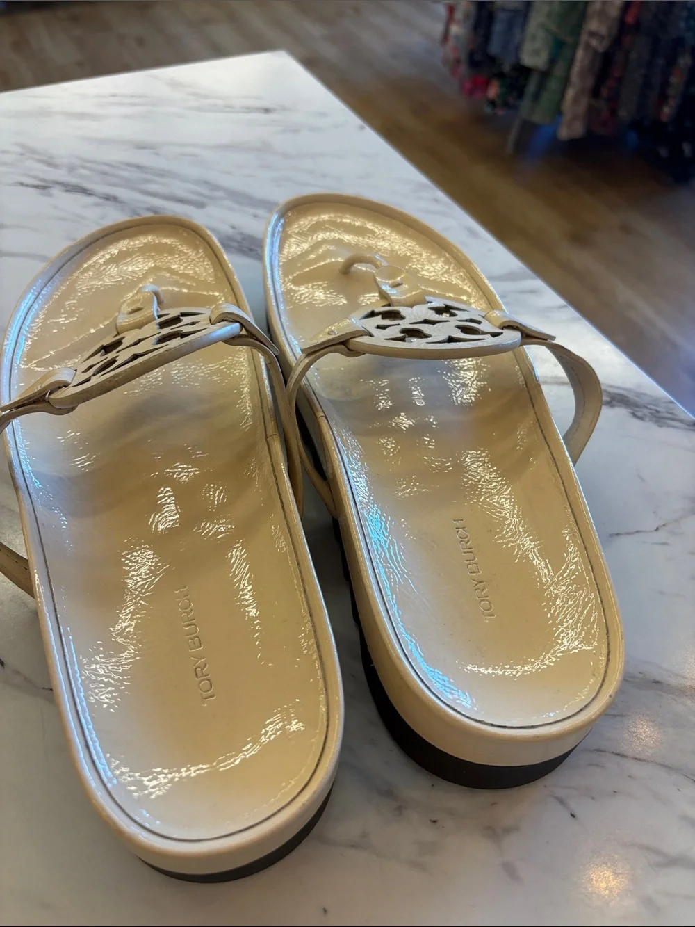 Tory Burch Patent Logo Thong Sandals in Light Beige with a chunky heel.